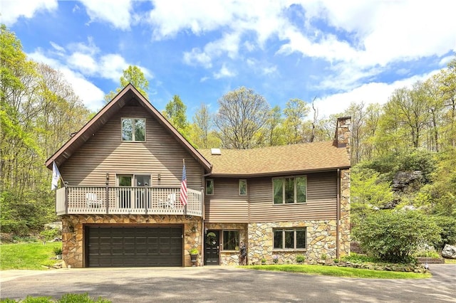 2847 National Pike, Wharton Twp, PA 15421 - view of front of home featuring stone siding, asphalt driveway, a balcony, a chimney, and a garage