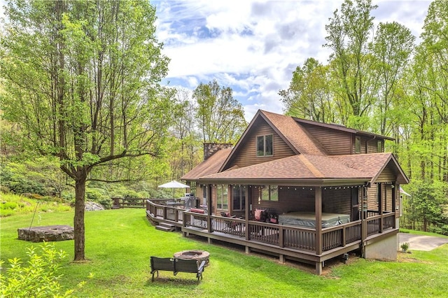 2847 National Pike, Wharton Twp, PA 15421 - rear view of house with a shingled roof, a fire pit, and a lawn