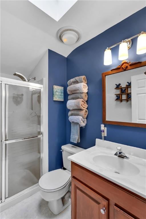 2847 National Pike, Wharton Twp, PA 15421 - full bath featuring a stall shower, vanity, toilet, and a skylight