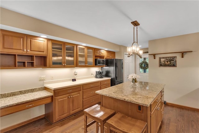 2847 National Pike, Wharton Twp, PA 15421 - kitchen featuring freestanding refrigerator, stainless steel microwave, wood finished floors, and brown cabinets