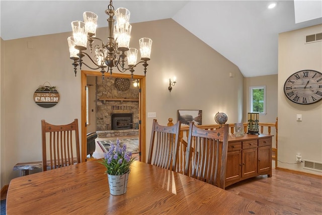 2847 National Pike, Wharton Twp, PA 15421 - dining area with vaulted ceiling, light wood finished floors, a chandelier, baseboards, and a fireplace