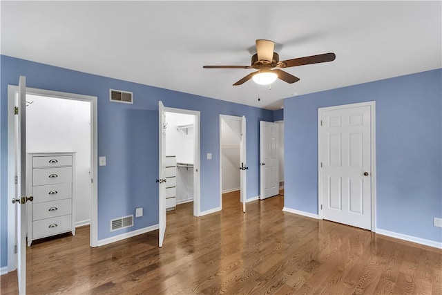2847 National Pike, Wharton Twp, PA 15421 - unfurnished bedroom featuring baseboards, wood finished floors, a walk in closet, and ceiling fan