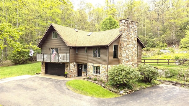 2847 National Pike, Wharton Twp, PA 15421 - view of front of house featuring asphalt driveway, stone siding, a balcony, a chimney, and a view of trees