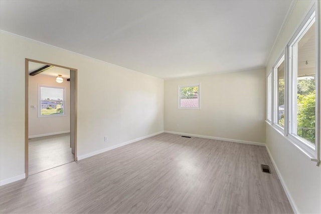 unfurnished room featuring light wood-style floors and baseboards