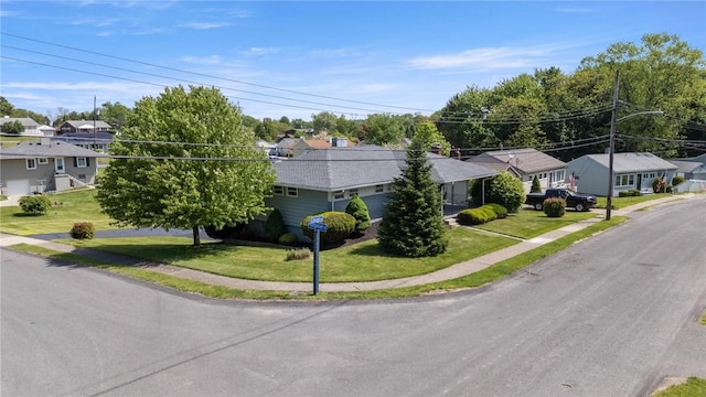 view of front of home featuring a residential view and a front lawn