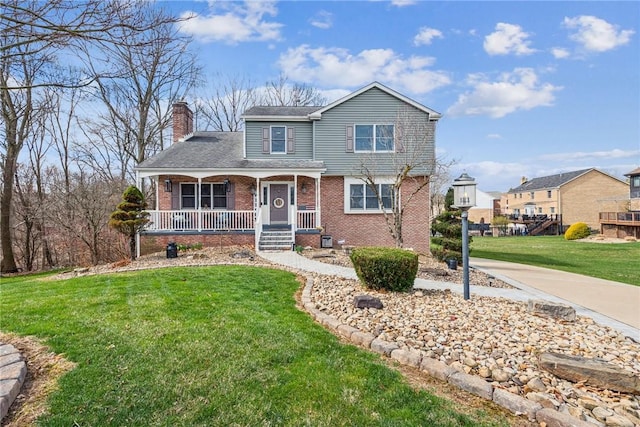 traditional-style house featuring covered porch, brick siding, a chimney, and a front lawn
