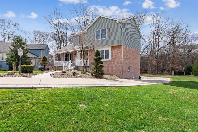 view of front of house with brick siding and a front yard