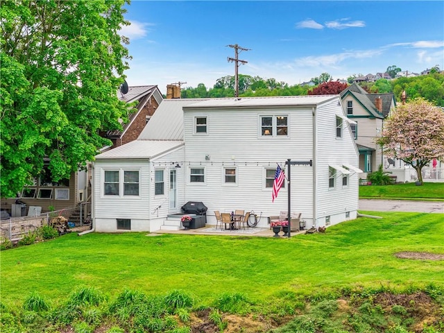 707 Atlantic Ave, Monaca, PA 15061 - rear view of property with metal roof, a patio area, and a yard