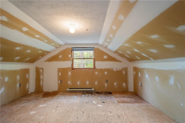 297 Alamae Lakes Rd, South Franklin, PA 15301 - additional living space with a baseboard heating unit, vaulted ceiling, a textured ceiling, and wood finished floors