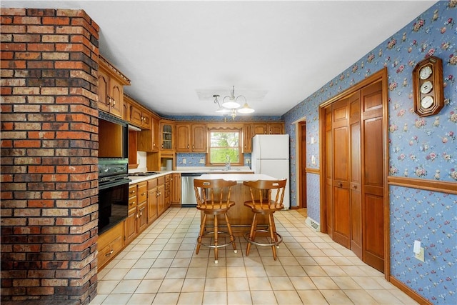 297 Alamae Lakes Rd, South Franklin, PA 15301 - kitchen with black oven, wallpapered walls, freestanding refrigerator, light countertops, and stainless steel dishwasher