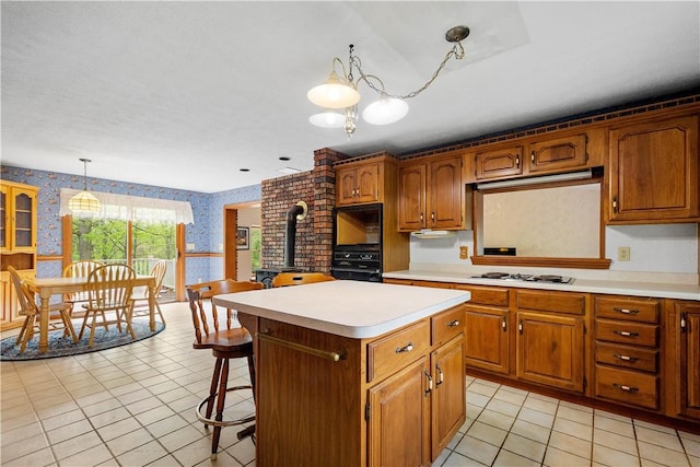 297 Alamae Lakes Rd, South Franklin, PA 15301 - kitchen featuring wallpapered walls, a wood stove, black oven, white cooktop, and light countertops