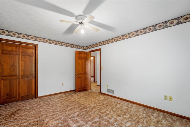 297 Alamae Lakes Rd, South Franklin, PA 15301 - unfurnished bedroom featuring baseboards, carpet floors, a closet, and a ceiling fan