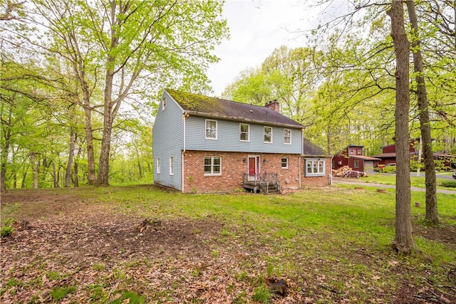 297 Alamae Lakes Rd, South Franklin, PA 15301 - rear view of property with a chimney, brick siding, and a yard