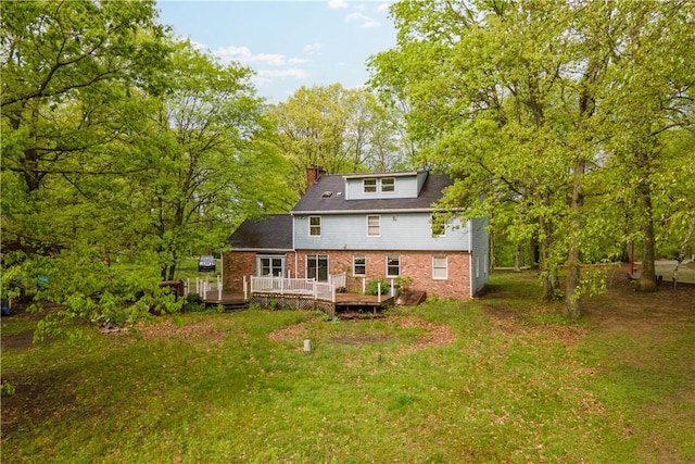 297 Alamae Lakes Rd, South Franklin, PA 15301 - rear view of property featuring brick siding, a chimney, a deck, and a yard