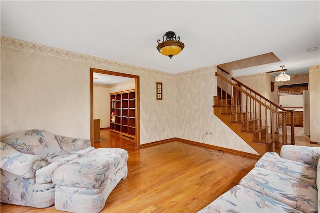 297 Alamae Lakes Rd, South Franklin, PA 15301 - living room with wood finished floors, stairway, baseboards, and wallpapered walls