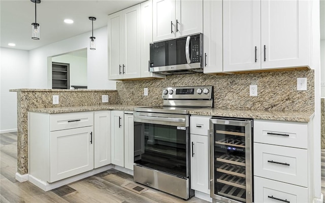 kitchen featuring beverage cooler, stainless steel appliances, light wood-style floors, white cabinets, and tasteful backsplash