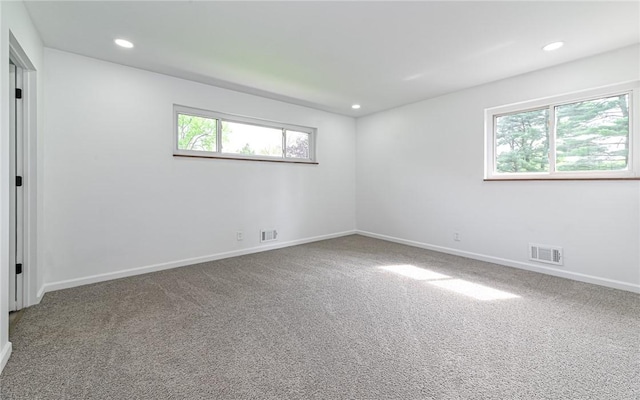 spare room featuring carpet floors, recessed lighting, and baseboards