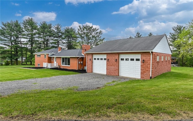 view of front facade with a chimney, a front yard, and brick siding