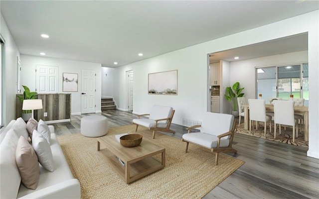 living area featuring wood finished floors, stairway, recessed lighting, and baseboards