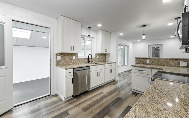 kitchen with stainless steel appliances, dark wood finished floors, white cabinetry, backsplash, and recessed lighting