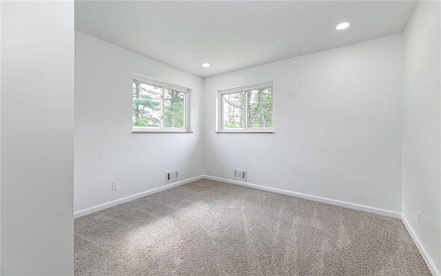 carpeted empty room with baseboards and recessed lighting