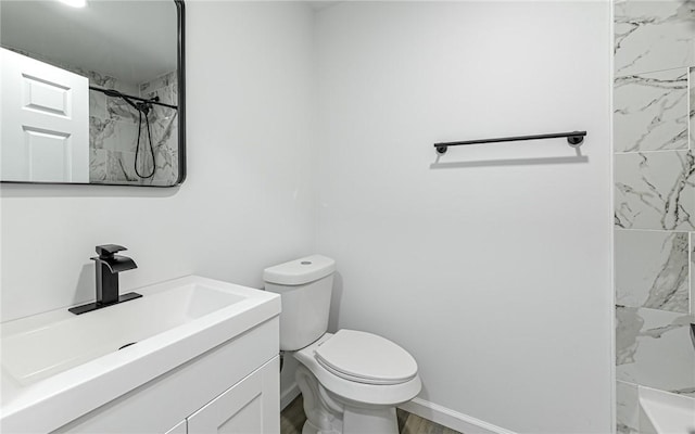 full bath with toilet, vanity, a shower, and baseboards