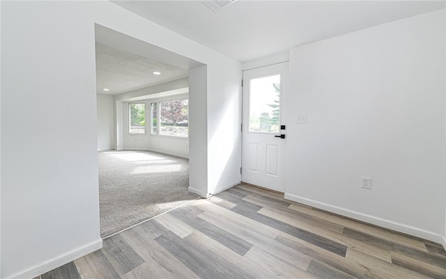 foyer entrance with baseboards, wood finished floors, and recessed lighting