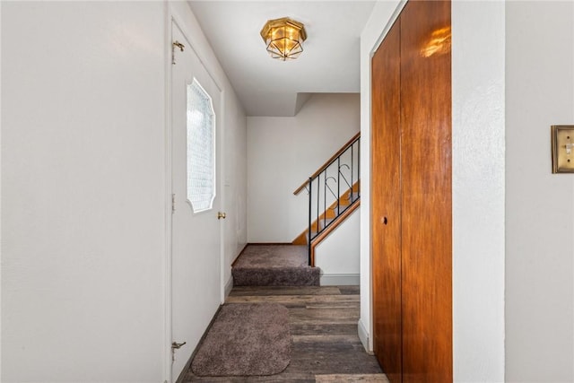 stairs featuring wood finished floors and baseboards