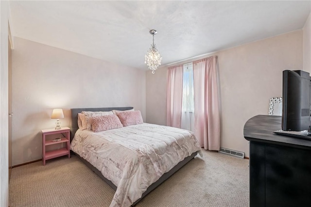 carpeted bedroom with baseboards and a chandelier