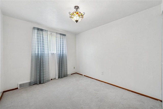 unfurnished room with carpet and baseboards