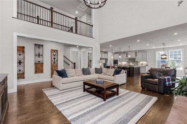 521 Cambridge Ct, Pine Twp Nal, PA 15090 - living room with dark wood-style flooring, a chandelier, stairway, a high ceiling, and baseboards
