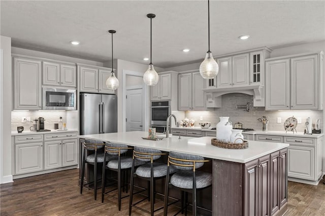 521 Cambridge Ct, Pine Twp Nal, PA 15090 - kitchen with appliances with stainless steel finishes, backsplash, light countertops, dark wood-type flooring, and recessed lighting