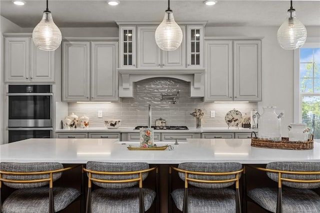 521 Cambridge Ct, Pine Twp Nal, PA 15090 - kitchen featuring stainless steel appliances, glass insert cabinets, decorative backsplash, a breakfast bar area, and recessed lighting