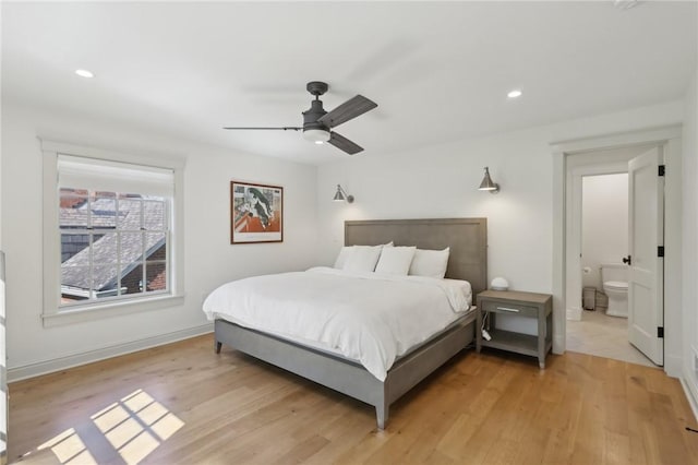 bedroom featuring light wood-type flooring, recessed lighting, baseboards, a ceiling fan, and ensuite bath