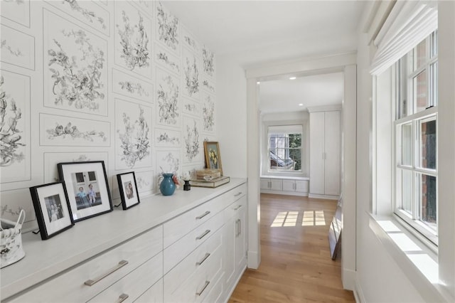 corridor featuring light wood-style flooring and recessed lighting