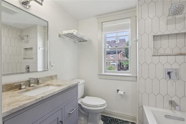 full bathroom with toilet, baseboards, vanity, and washtub / shower combination