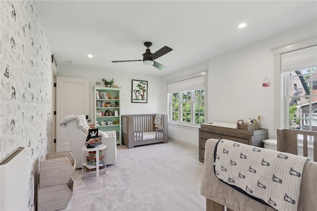bedroom featuring baseboards, wallpapered walls, light carpet, recessed lighting, and a ceiling fan
