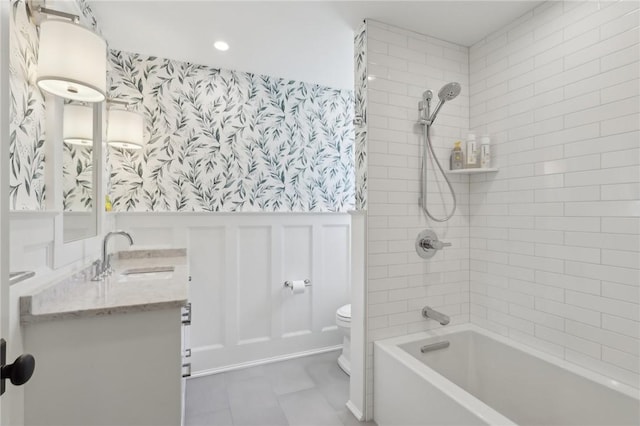full bath with wallpapered walls, toilet, wainscoting, shower / tub combination, and vanity