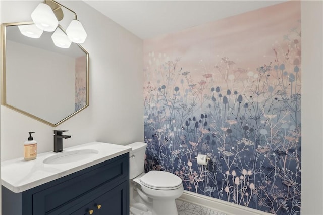 bathroom featuring toilet and vanity