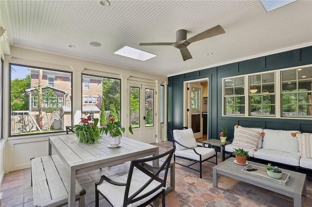sunroom / solarium with a skylight and french doors