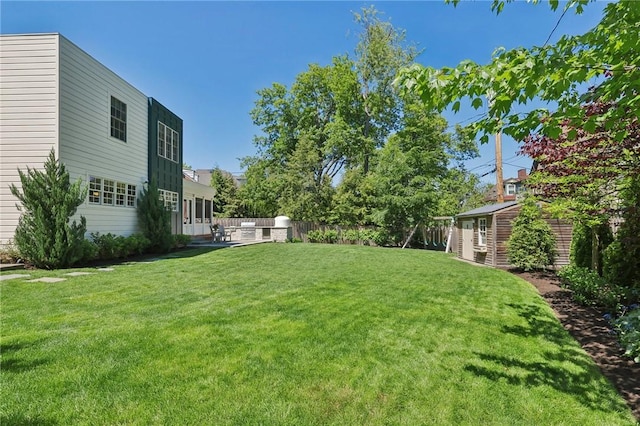 view of yard with an outbuilding and a patio