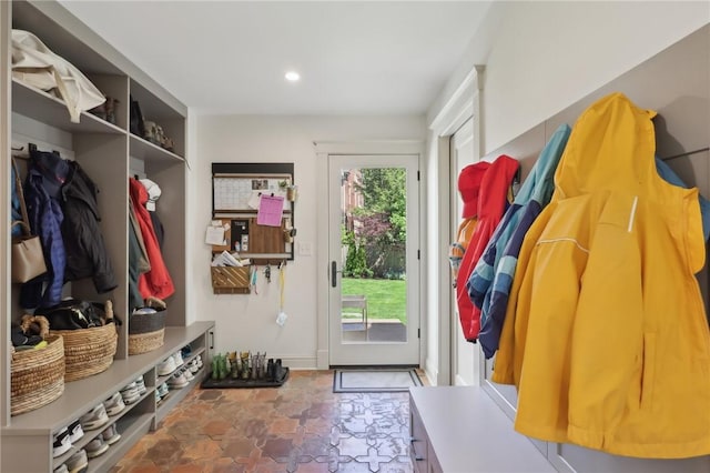 mudroom featuring stone finish floors and recessed lighting