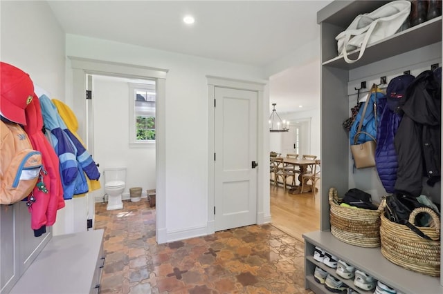 mudroom with a chandelier, stone finish flooring, and recessed lighting