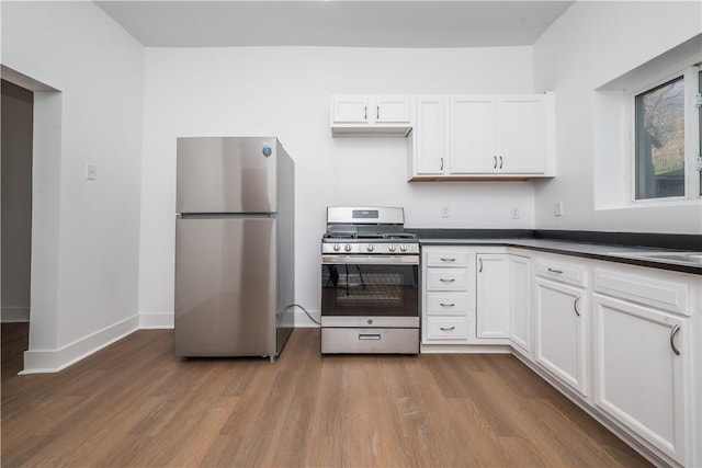 61 Greenbush St, Mt Washington, PA 15211 - kitchen featuring stainless steel appliances, wood finished floors, dark countertops, and white cabinets