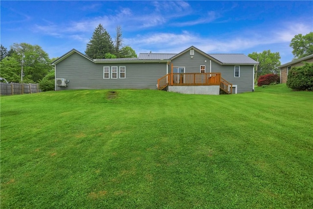 back of house featuring a deck and metal roof