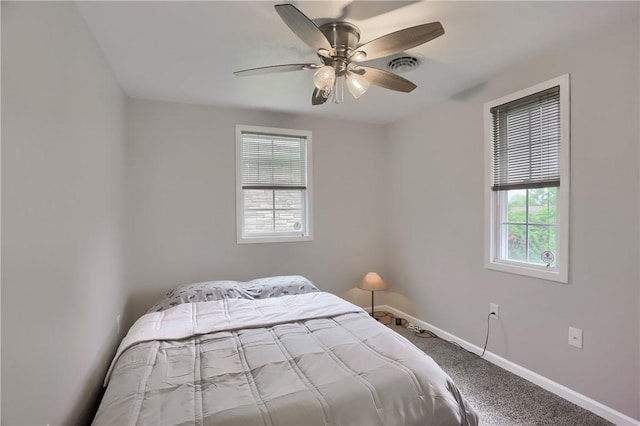 carpeted bedroom featuring baseboards and ceiling fan