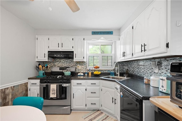 kitchen with stainless steel gas stove, dishwasher, range hood, a sink, and dark countertops