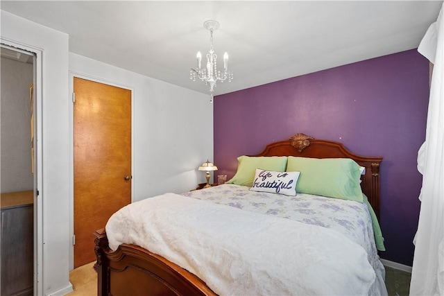 carpeted bedroom featuring a chandelier