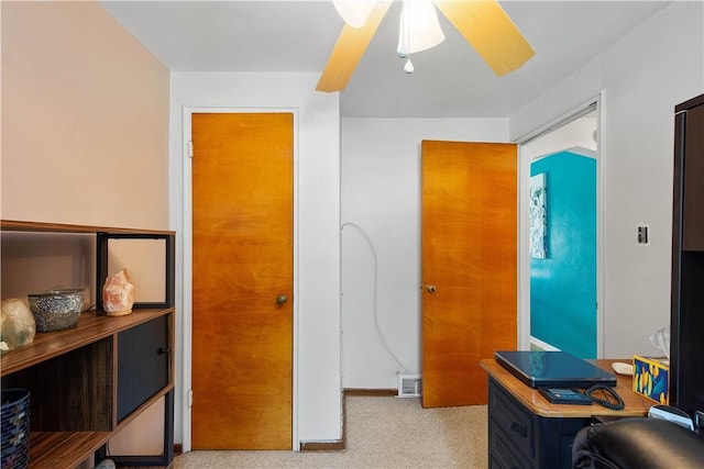 office area with carpet floors, a ceiling fan, and baseboards