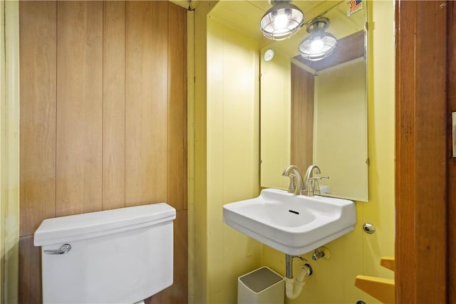half bathroom with toilet and a sink